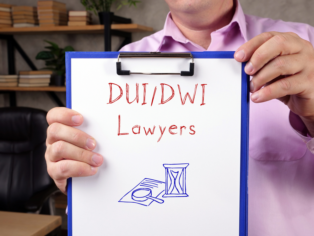 A business concept highlighting DUI/DWI lawyers, represented by a sign or phrase written on a piece of paper.