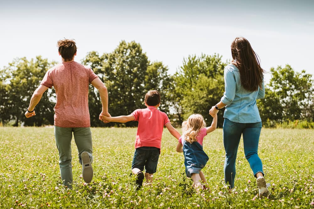 The scene captures the essence of a healthy, outdoor lifestyle, with lush greenery and clear skies symbolizing freedom, joy, and togetherness in nature.






