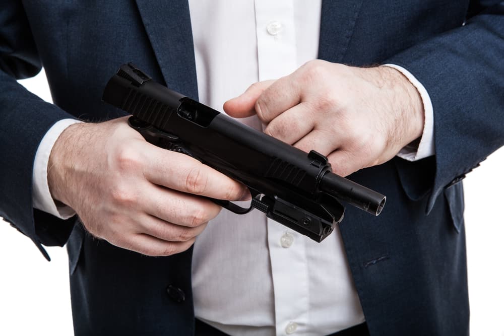 The image of a man holding a gun on a white background.