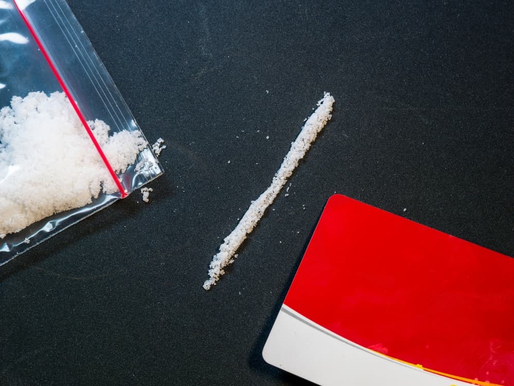 A illegal drug in clear bag with red stripped card